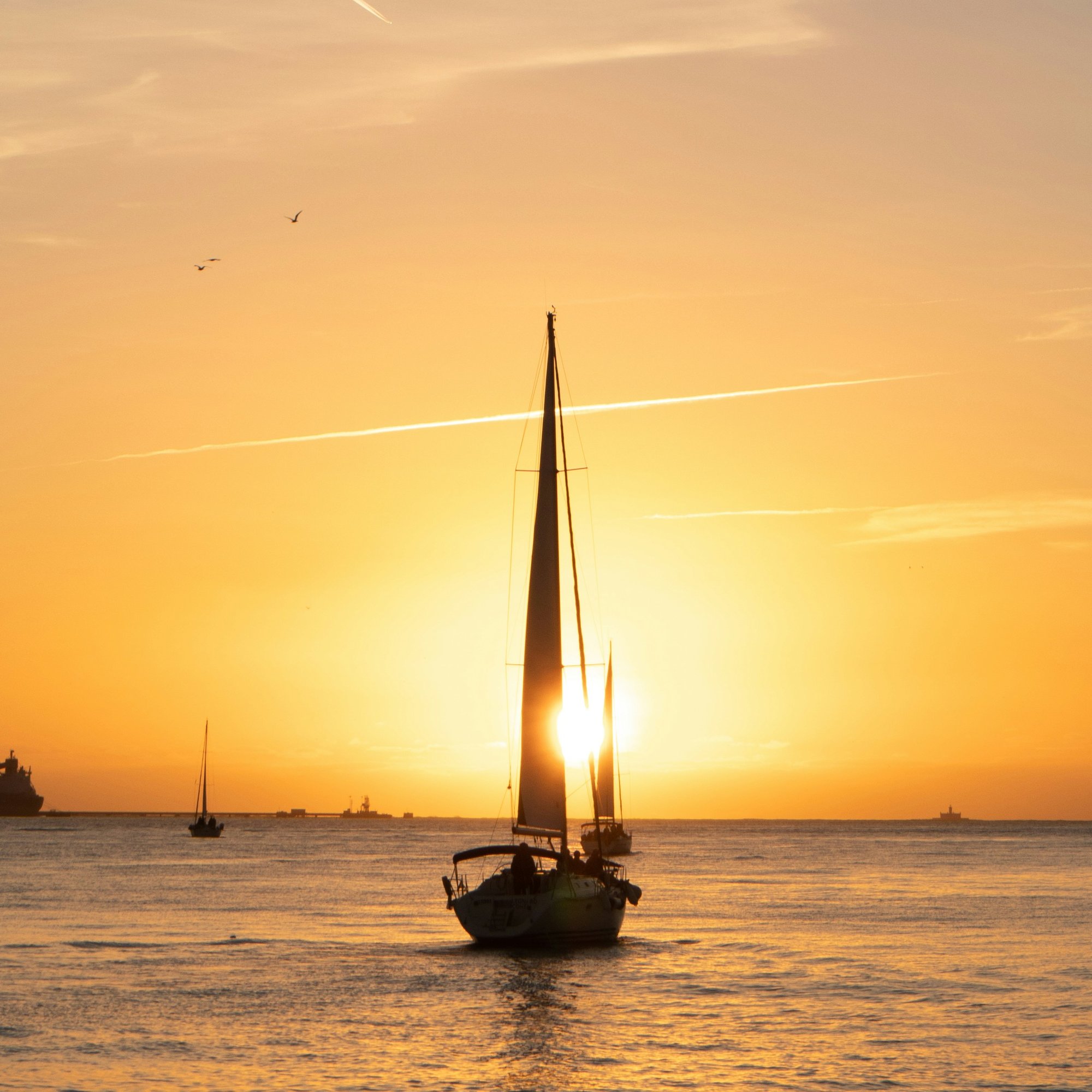Sailing boat navigating towards the horizon at sunset — symbolizing clarity and direction in AI product strategy